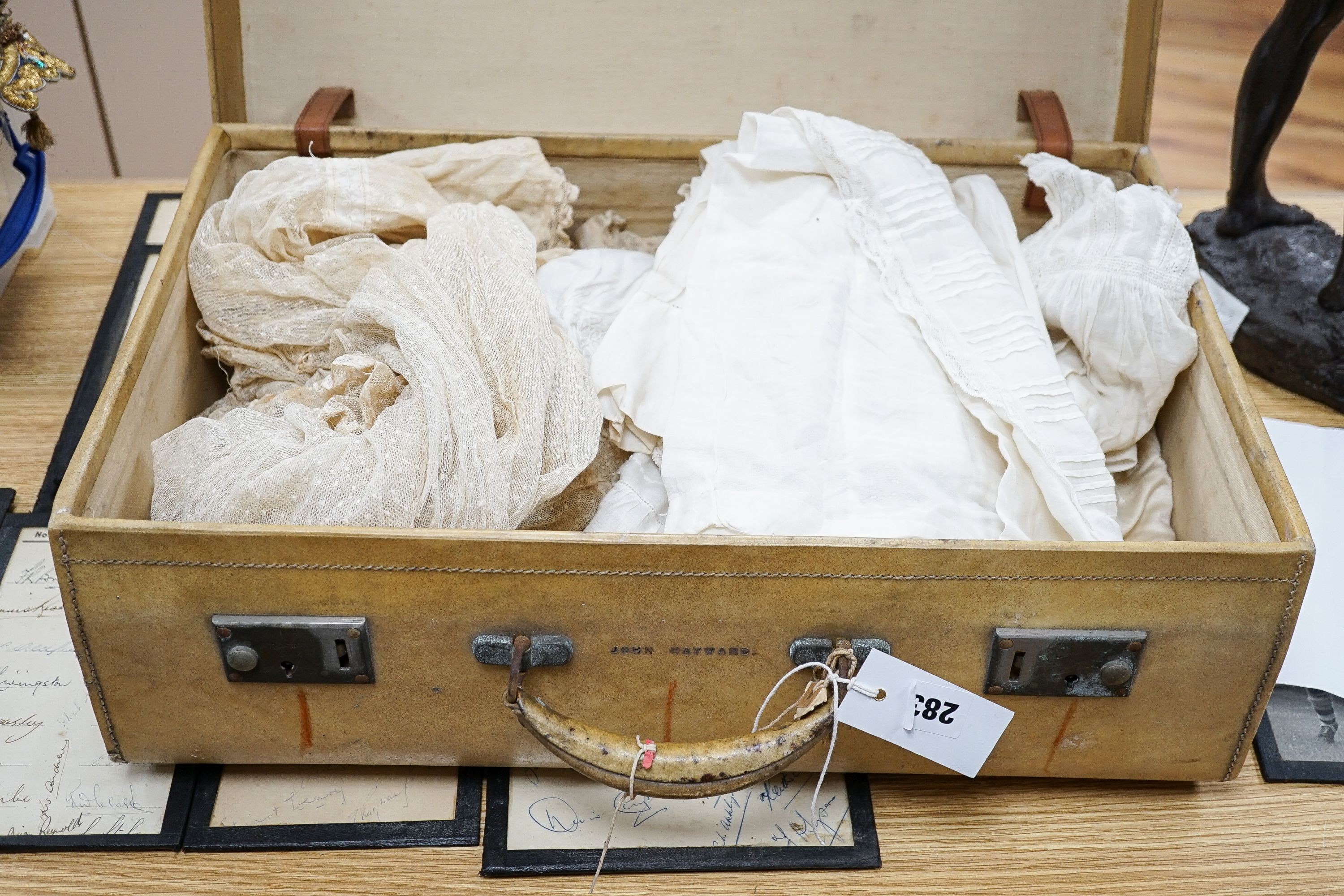 Various christening gowns, 2 dresses in a suitcase